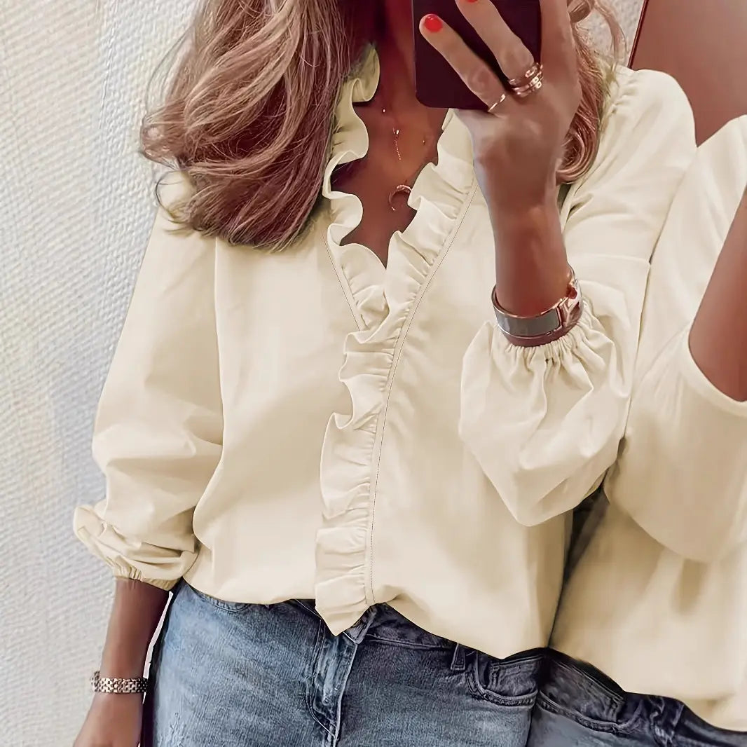 Blouse féminine fluide et élégante, manches longues à poignets élastiqués, volants décoratifs sur le col V et le buste, coloris variés, disponible en tailles S, M, L, XL et 2XL.