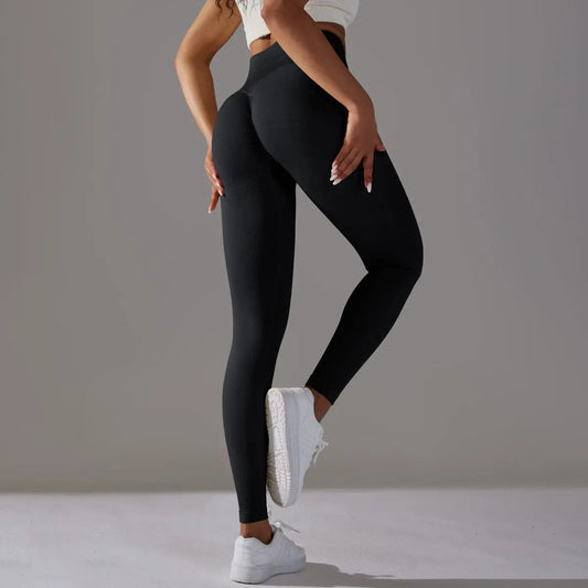 Legging de fitness noir vue de face, coupe ajustée et ceinture amincissante