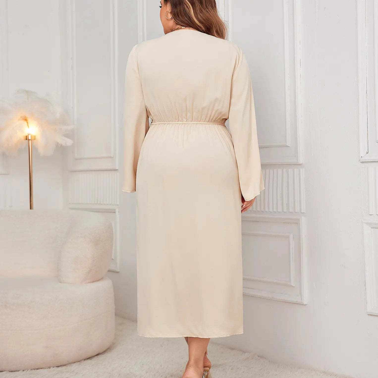 Robe longue fluide beige avec col cache-cœur et taille marquée.