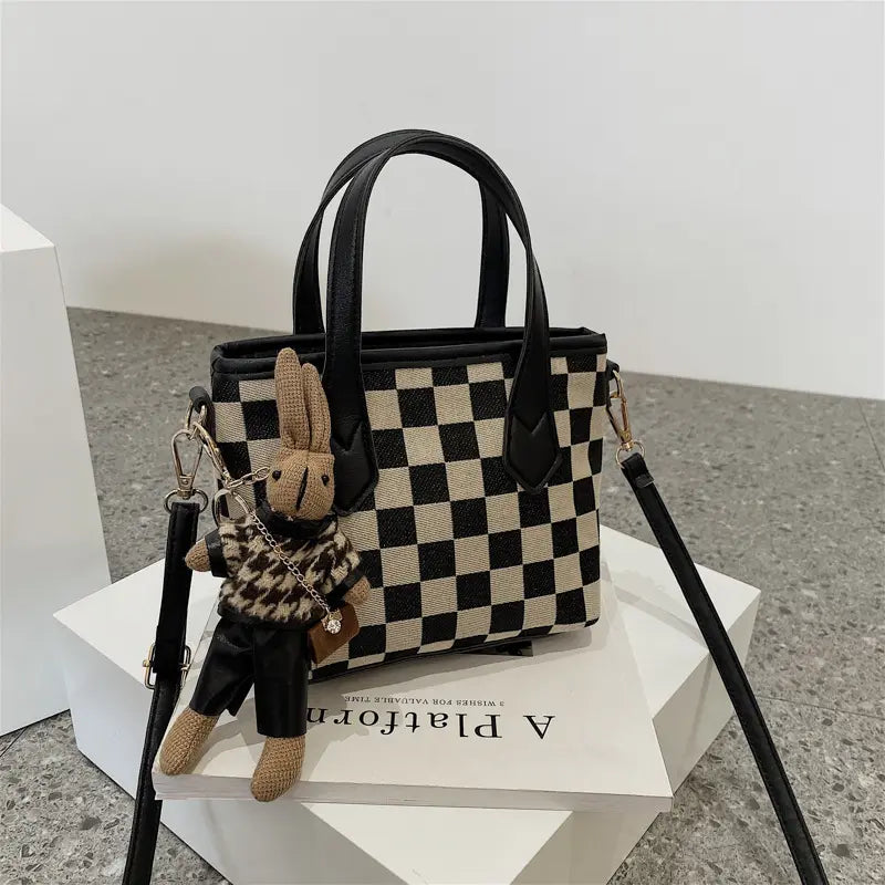 Détail des poignées du sac en laine femme, format compact.