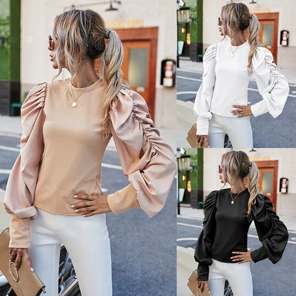 Top noir femme élégant et décontracté, manches longues sculptées bouffantes, style urban chic moderneHaut femme chic blanc, style urban chic, coupe ample tendance avec manches bouffantes et col rondTop femme urban chic taupe, coupe ample élégante avec manches longues bouffantes et encolure ras-du-cou